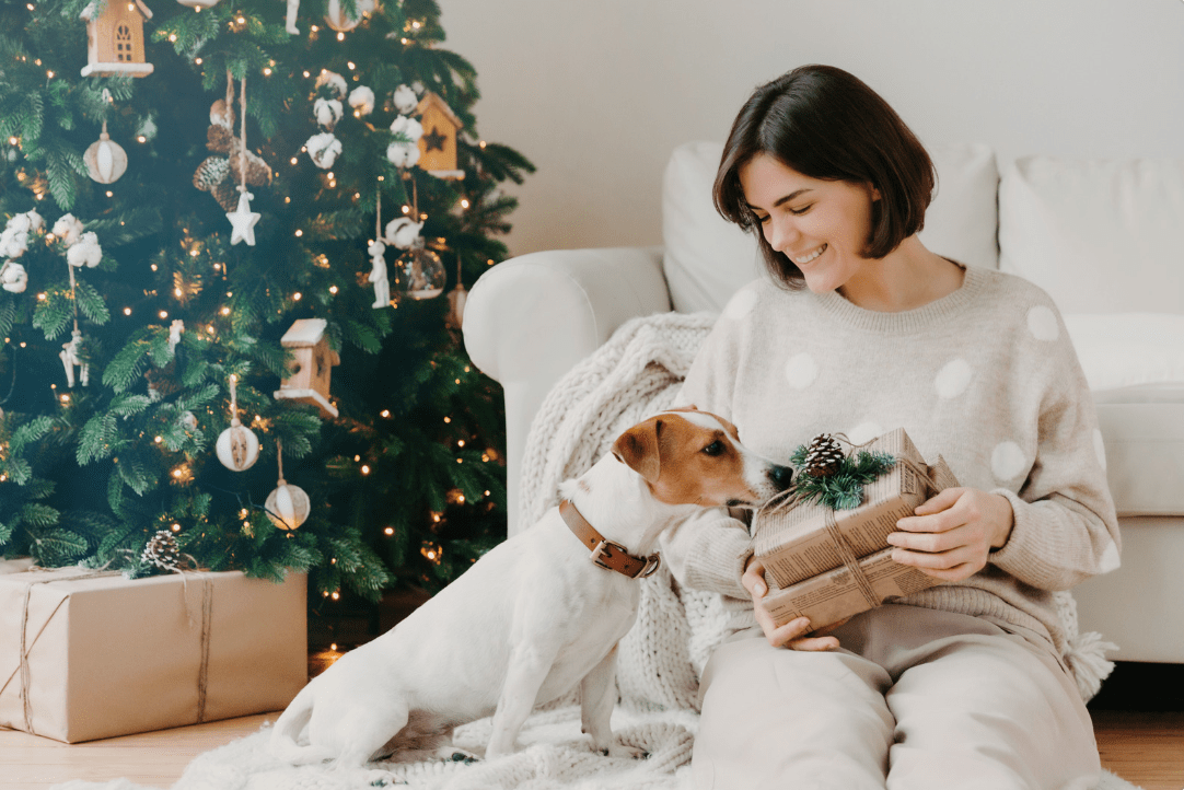 a woman giving her dog a present